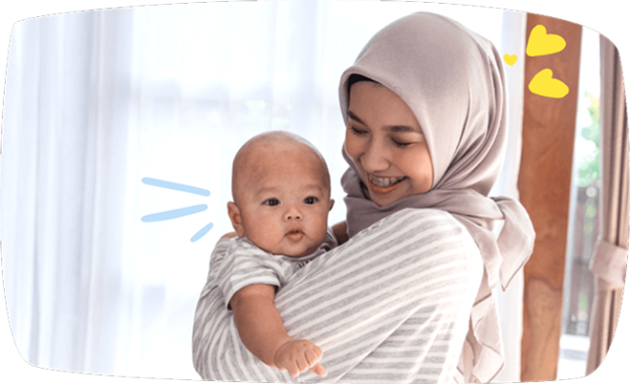 Babysitter smiling while holding a baby